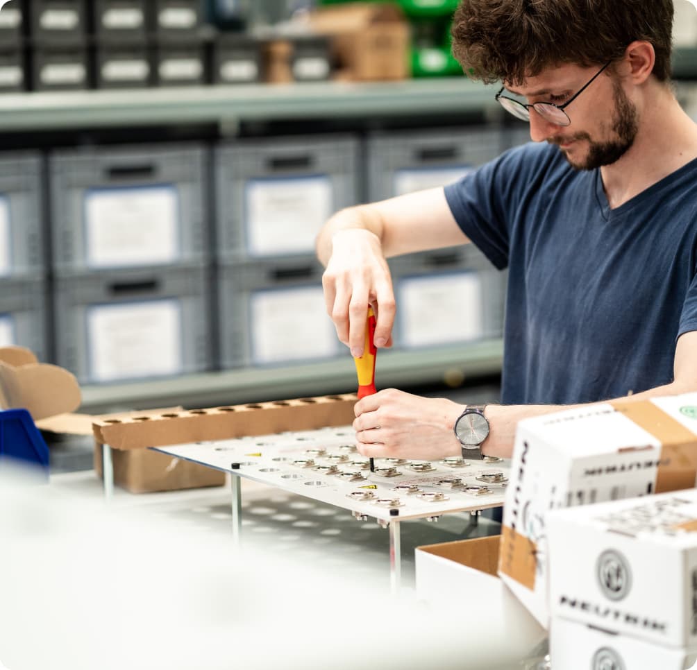 Technician assembling hardware in lab