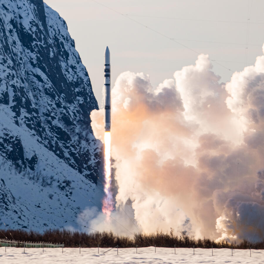 Rocket launch against snowy mountain backdrop